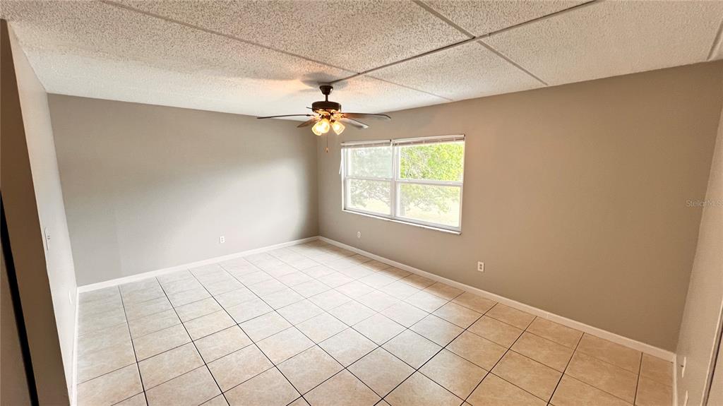 1902 Honour Road, Unit 24 Orlando, FL 32839 - Photo 9 of 25 an empty room with windows and fan
