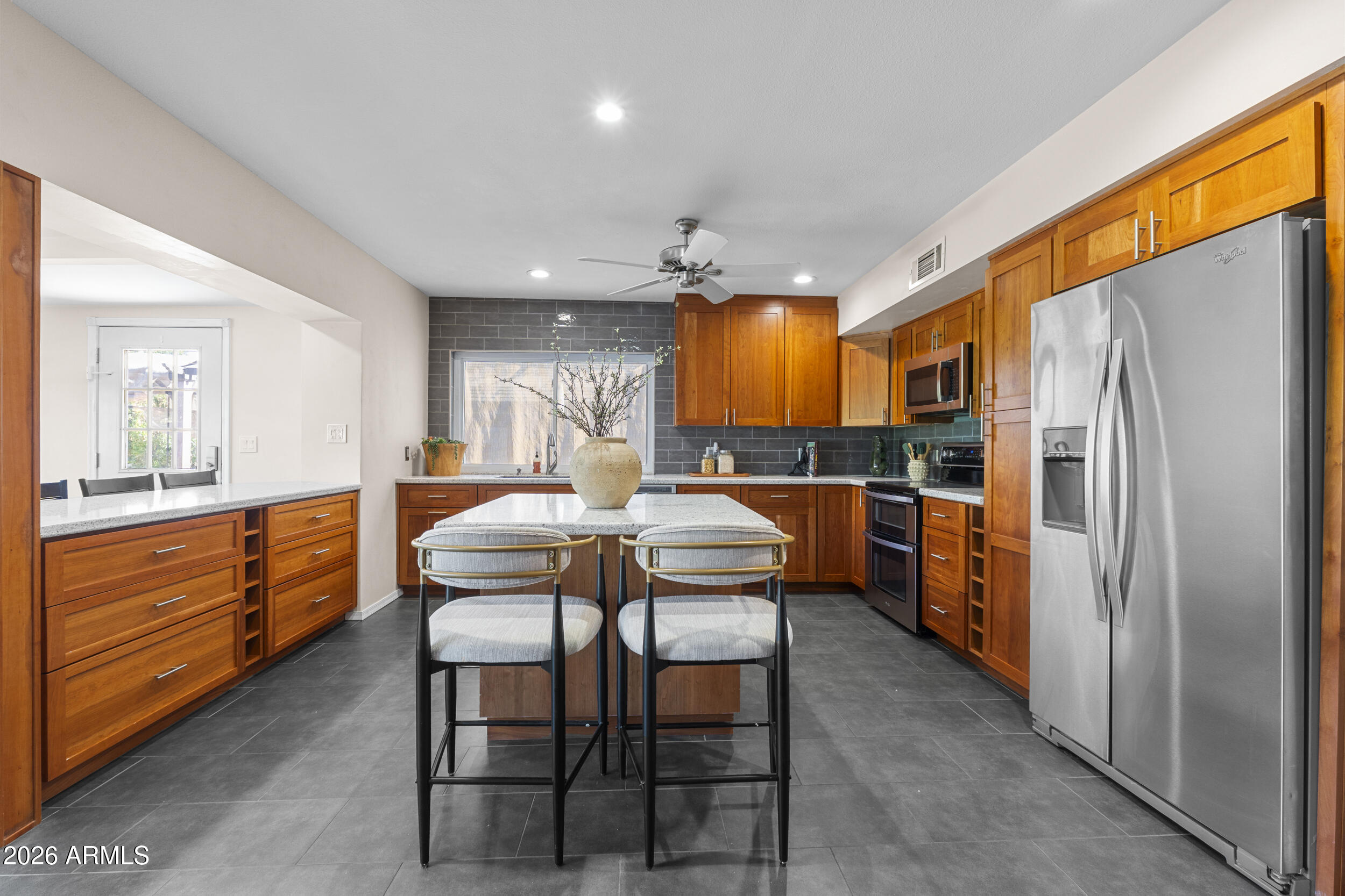 1608 East Weathervane Lane Tempe, AZ 85283 - Photo 9 of 33 a kitchen with a table chairs refrigerator and cabinets