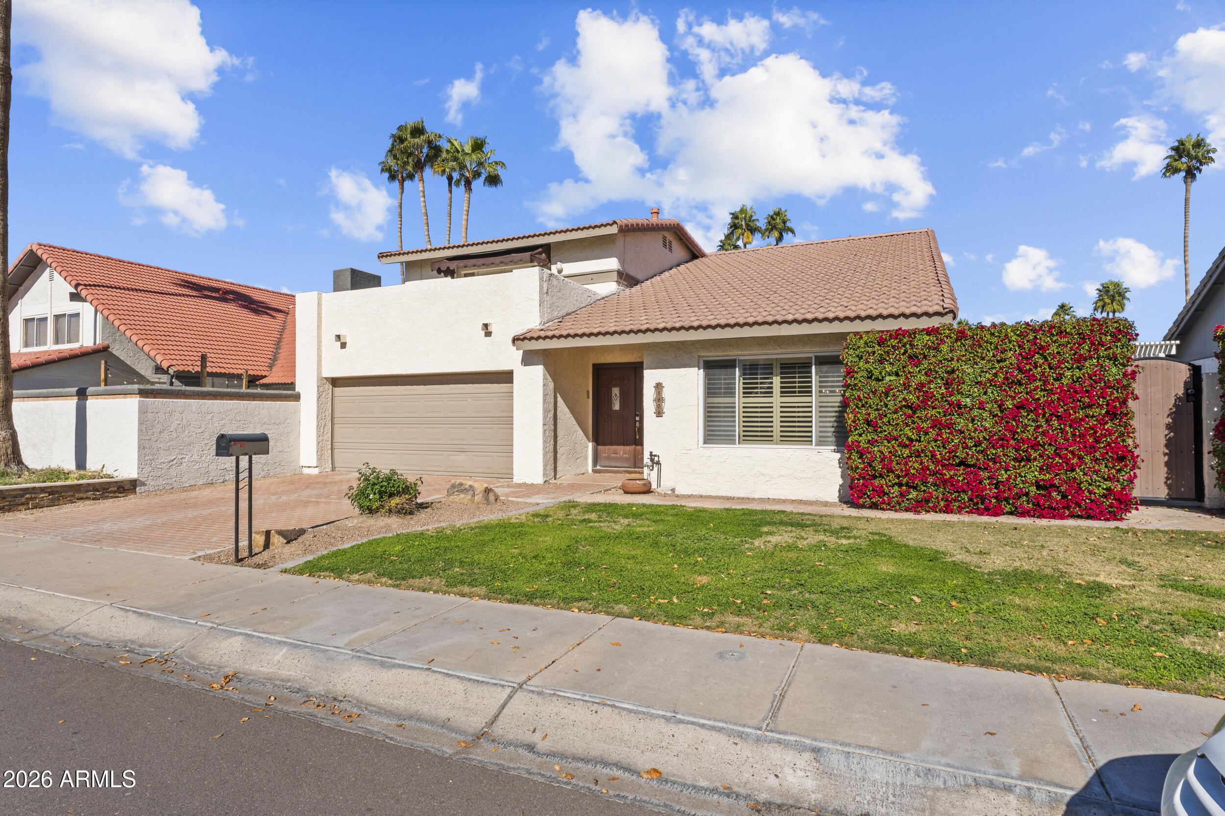 1608 East Weathervane Lane Tempe, AZ 85283 - Photo 3 of 33 a front view of a house with a yard and garage