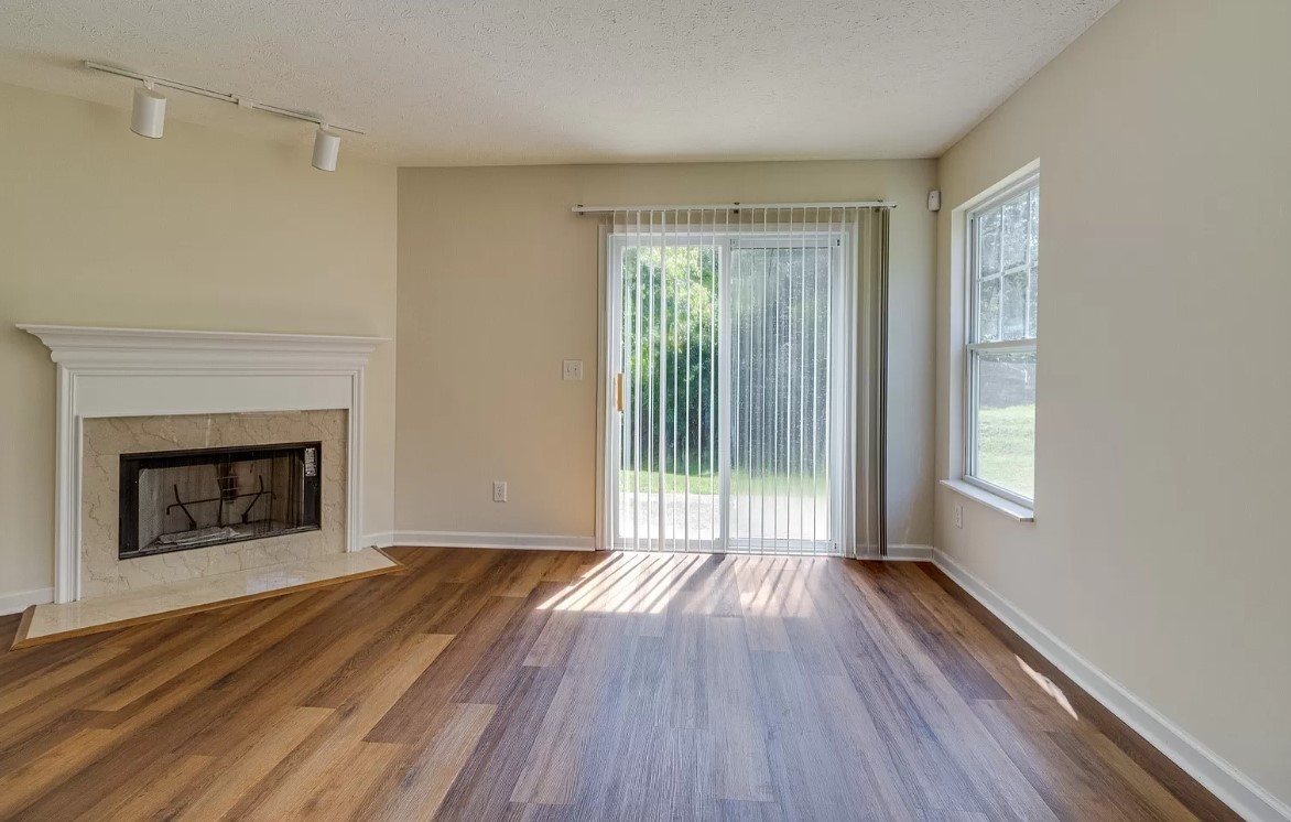 562 Flintlock Court Nashville, TN 37217 - Photo 7 of 20 a view of an empty room with wooden floor fireplace and a window