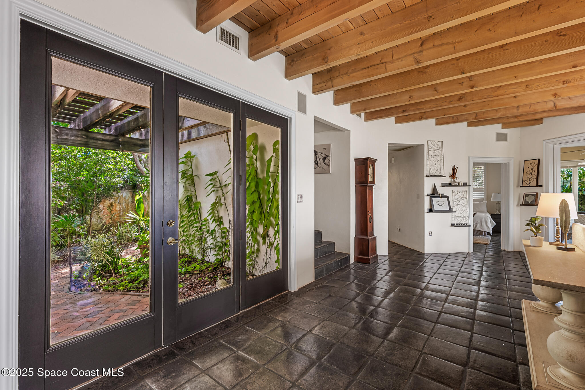 1025 Terry Drive Melbourne, FL 32935 - Photo 14 of 72 a view of empty room with wooden floor and floor to ceiling window