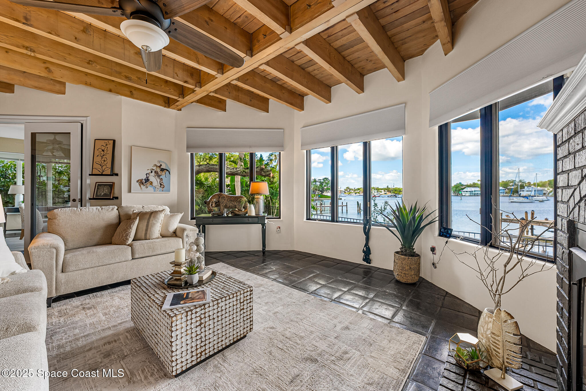 1025 Terry Drive Melbourne, FL 32935 - Photo 19 of 72 a living room with furniture large windows and wooden floor
