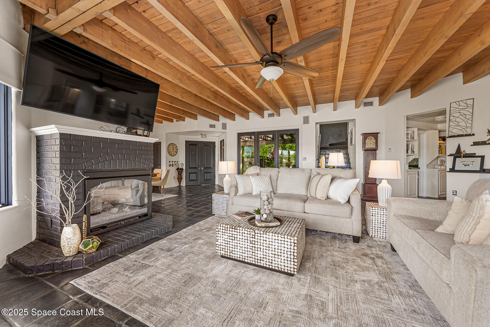 1025 Terry Drive Melbourne, FL 32935 - Photo 21 of 72 a living room with furniture and a fireplace