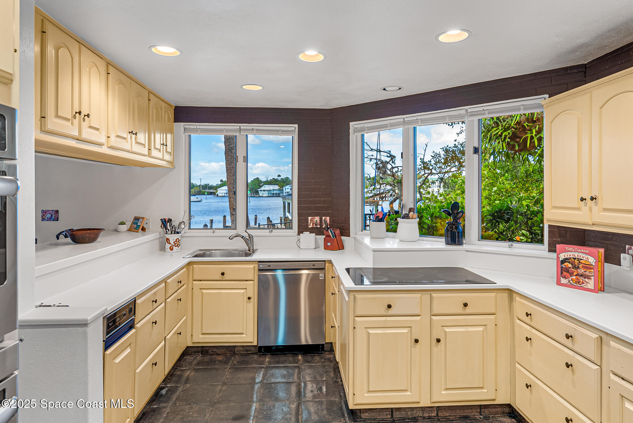 1025 Terry Drive Melbourne, FL 32935 - Photo 24 of 72 a kitchen with a sink stove and cabinets