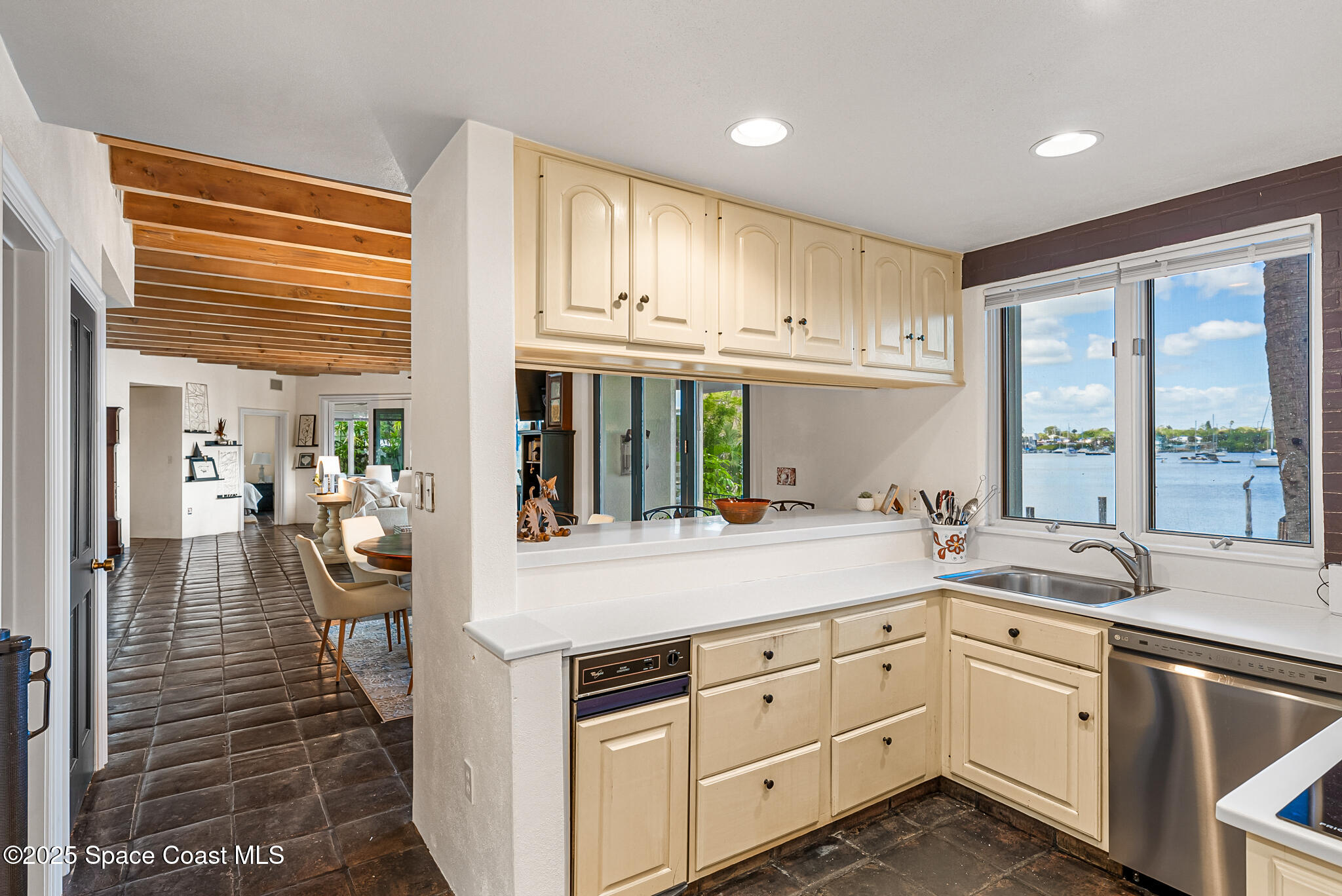 1025 Terry Drive Melbourne, FL 32935 - Photo 28 of 72 a kitchen with cabinets window and stainless steel appliances