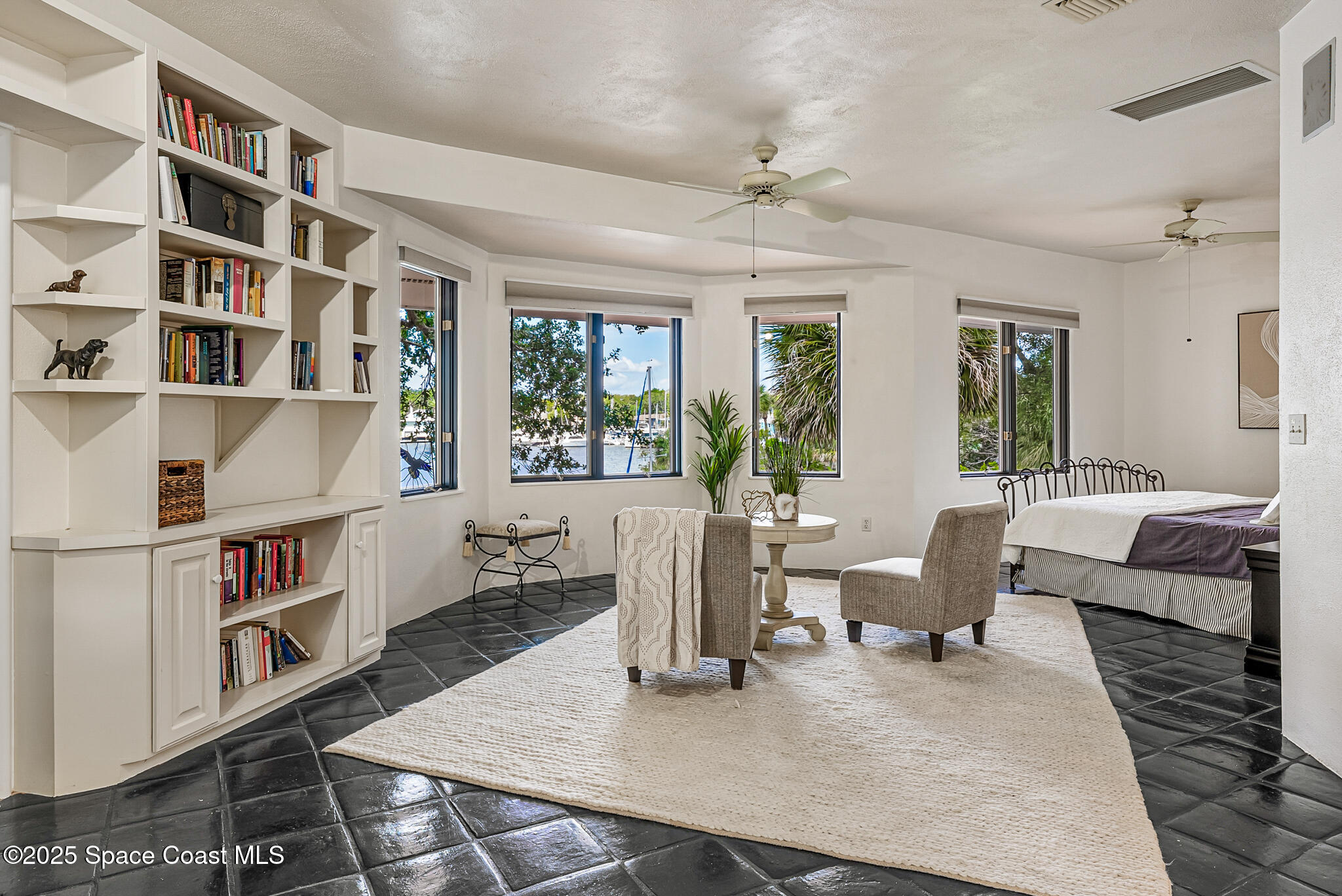1025 Terry Drive Melbourne, FL 32935 - Photo 39 of 72 a living room with furniture and a book shelf