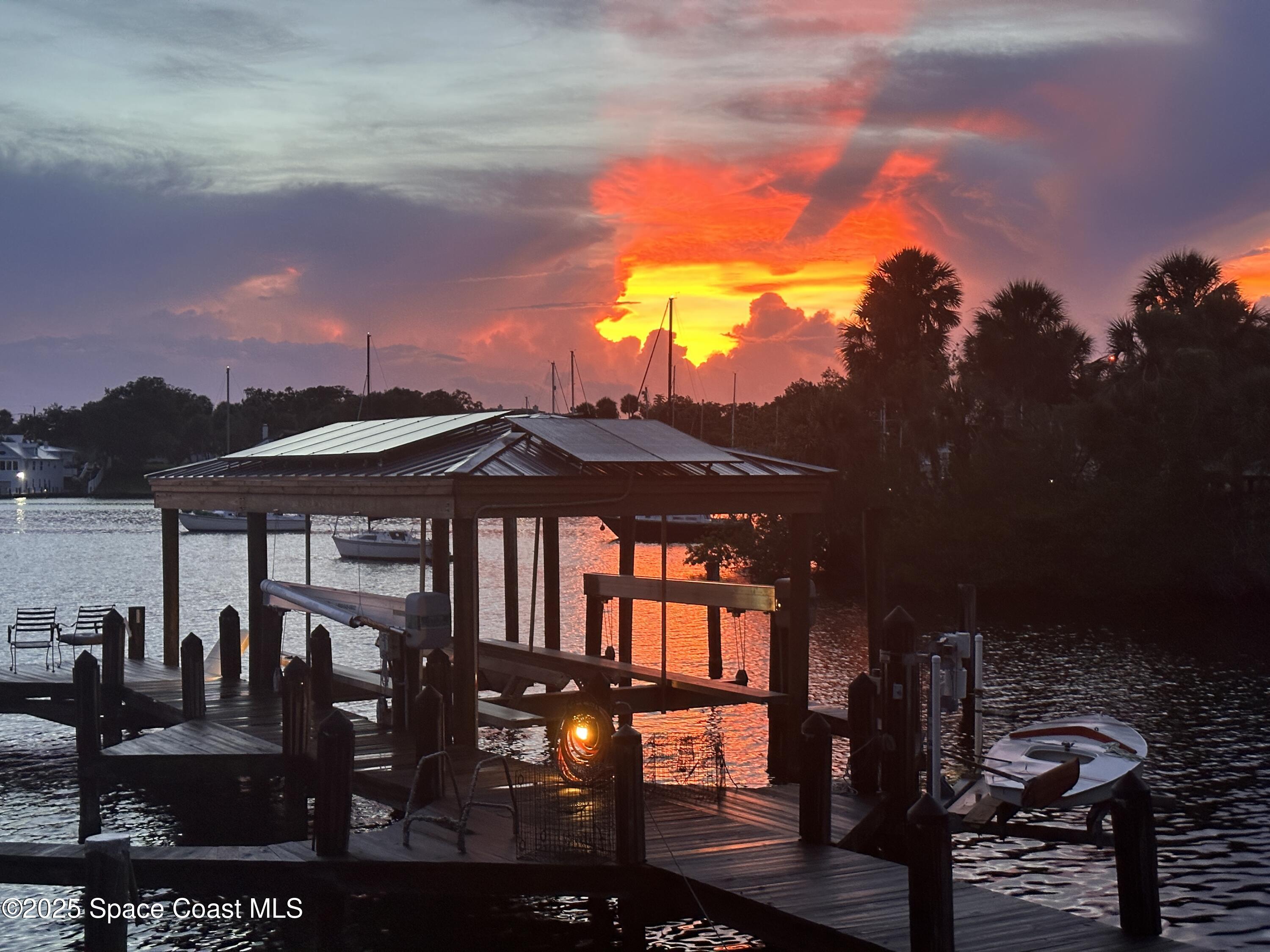 1025 Terry Drive Melbourne, FL 32935 - Photo 72 of 72 a view of a patio with a table and chairs under an umbrella