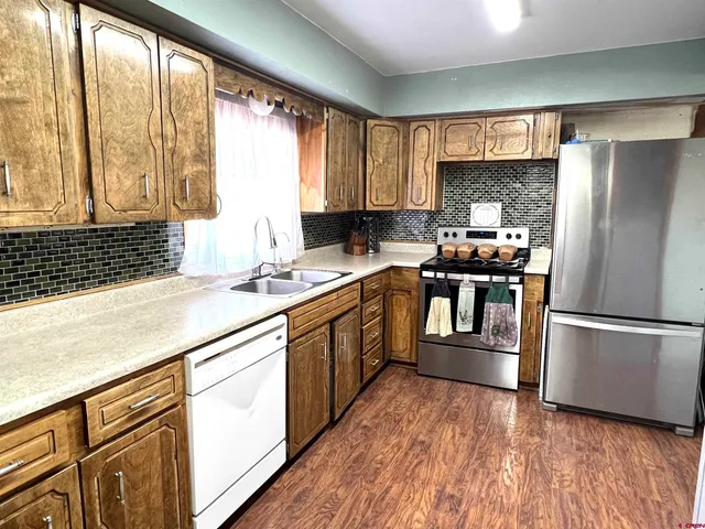 a view of kitchen with furniture and wooden floor