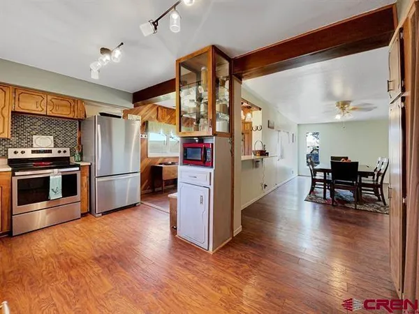 a view of a kitchen with a sink and wooden floor