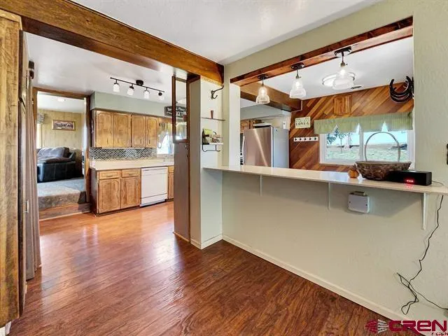 a living room with furniture and a kitchen