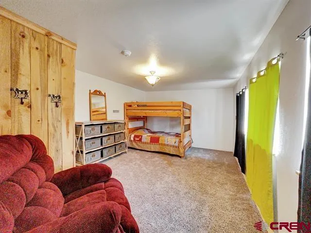 a bedroom with a bed and a mirror