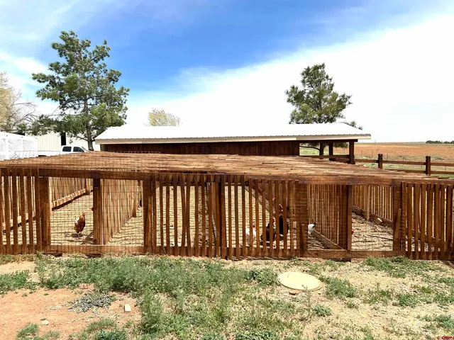 a view of a house with a yard and tree