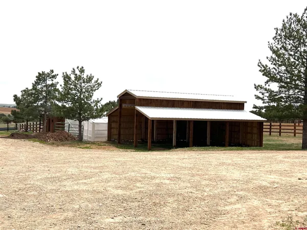 a view of a street with wooden fence