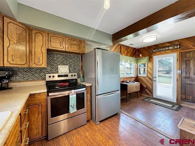 a kitchen with a refrigerator stove top oven and sink