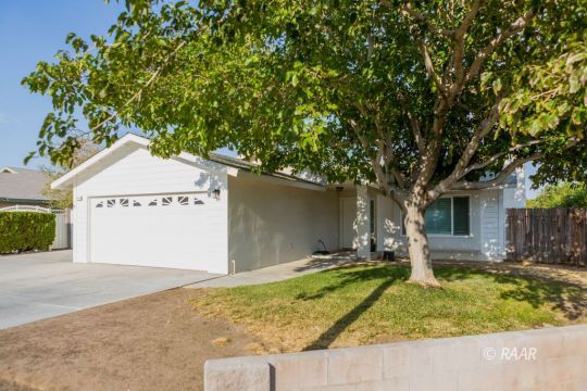 432 Ashton Street Ridgecrest, CA 93555 - Photo 1 of 31 a front view of a house with a yard and garage