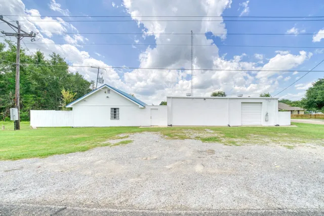a view of a house with a yard and a garage
