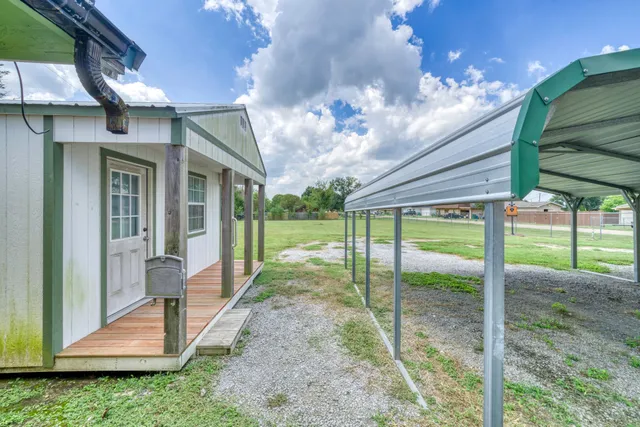 a view of a house with backyard porch and entertaining space