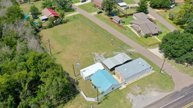 an aerial view of residential house with outdoor space and swimming pool