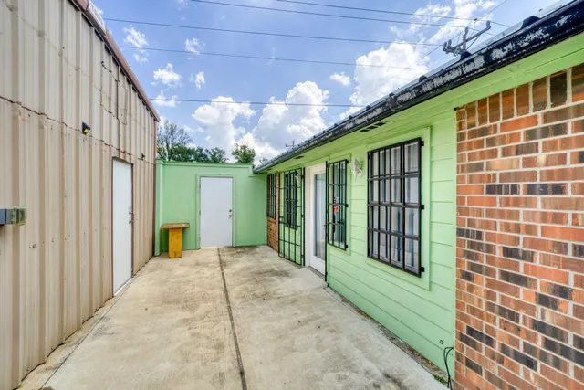 a view of a porch with a table and chairs