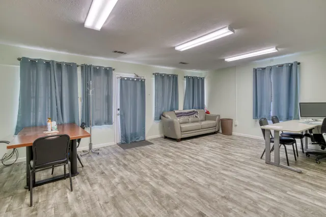 a living room with furniture a window and a table