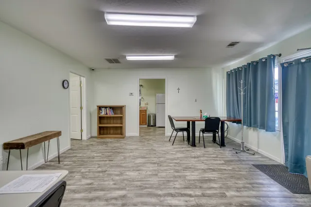 a view of a dining room with furniture and chandelier