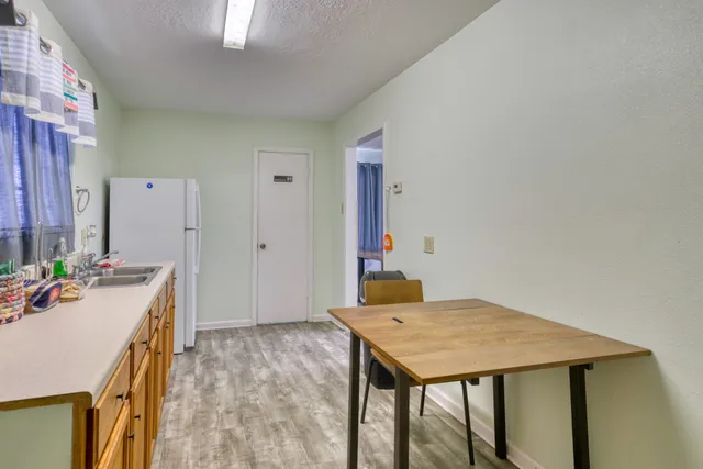 a view of a kitchen with a table and chairs