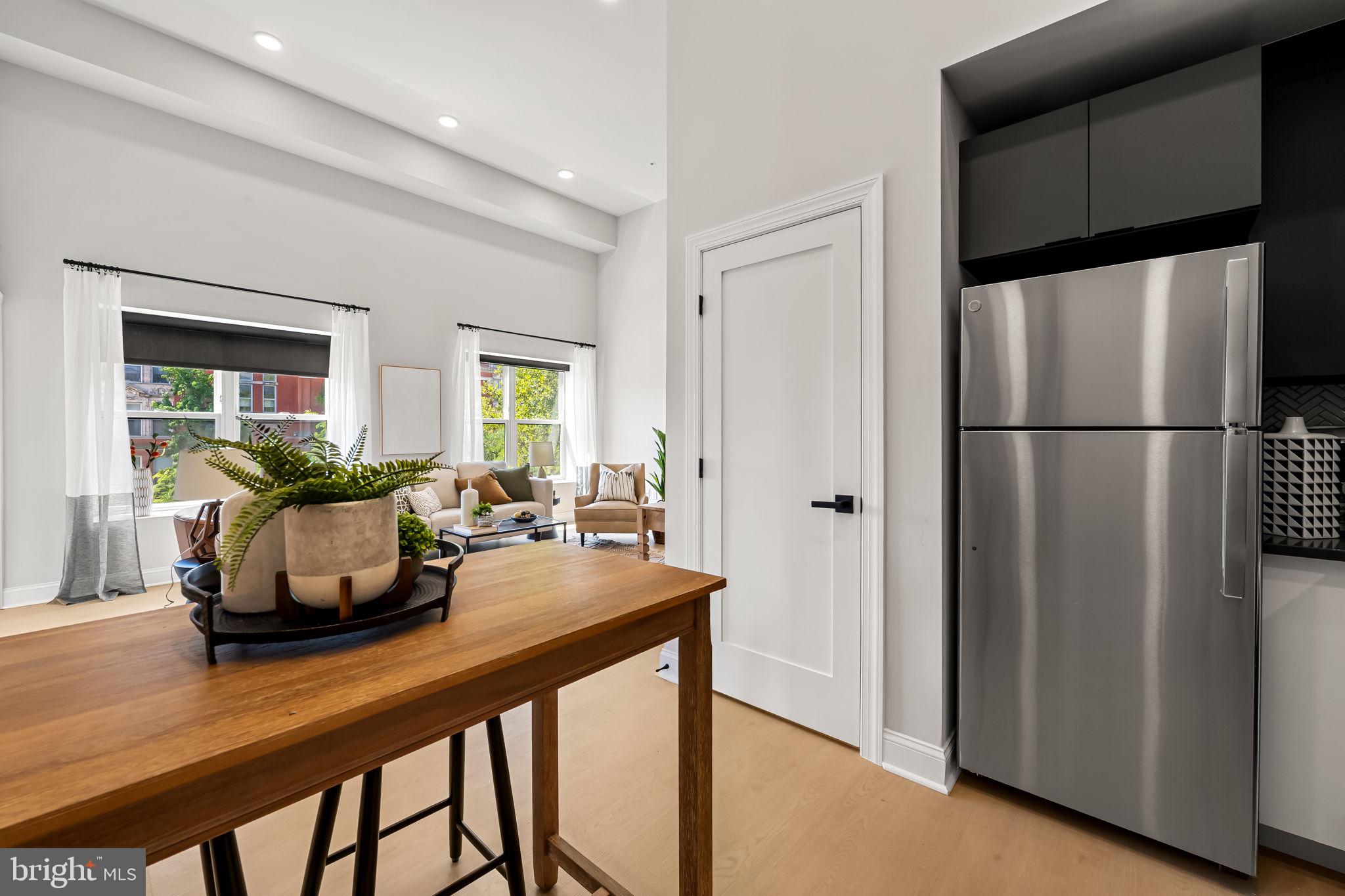 600 North Howard Street, Unit 102 Baltimore, MD 21201 - Photo 8 of 20 a kitchen with a refrigerator and a table