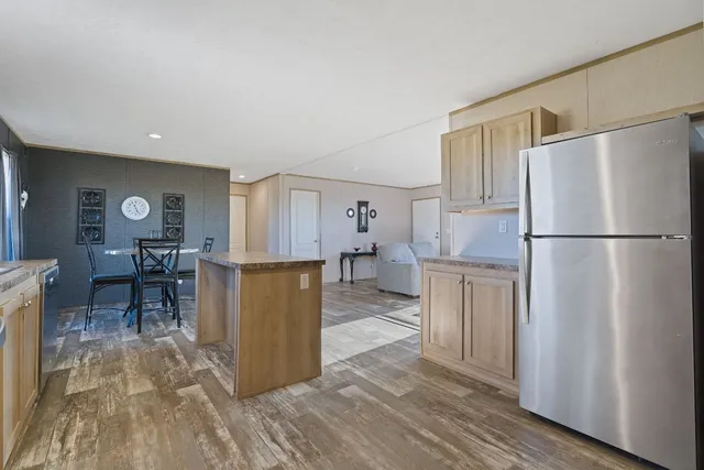 a kitchen with stainless steel appliances a stove a sink dishwasher and cabinets with wooden floor