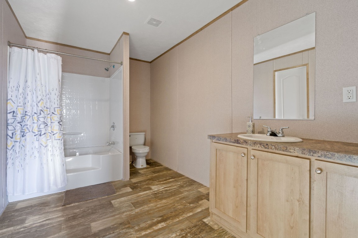 5897 Old Colony Line Road Lockhart, TX 78644 - Photo 30 of 40 a bathroom with a granite countertop sink a toilet and shower