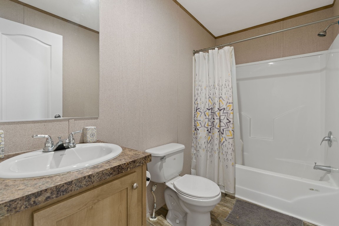 5897 Old Colony Line Road Lockhart, TX 78644 - Photo 32 of 40 a bathroom with a granite countertop sink toilet and shower