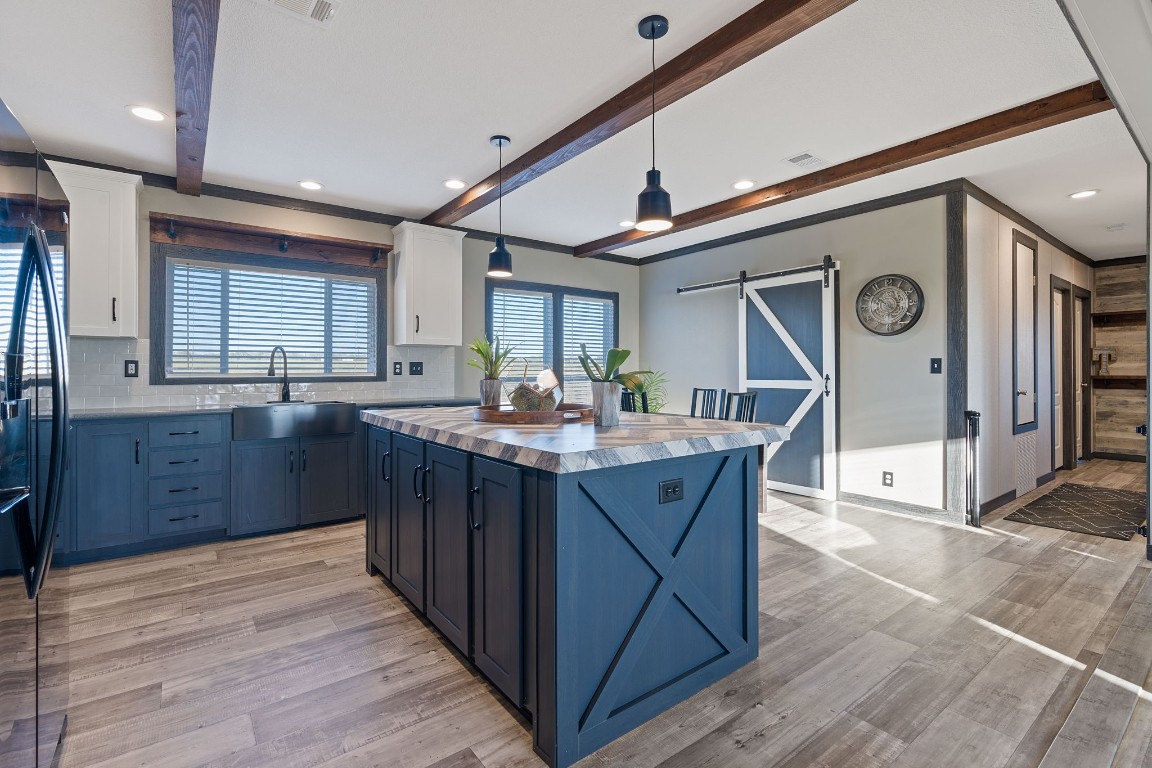 5897 Old Colony Line Road Lockhart, TX 78644 - Photo 6 of 40 a kitchen with granite countertop a sink cabinets and wooden floor
