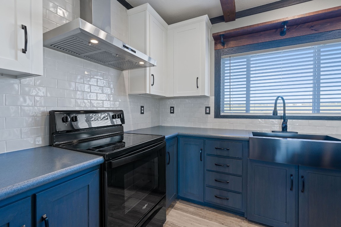 5897 Old Colony Line Road Lockhart, TX 78644 - Photo 7 of 40 a kitchen with granite countertop a stove sink and cabinets