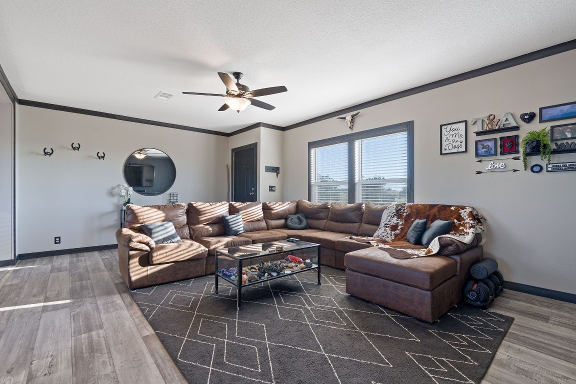 5897 Old Colony Line Road Lockhart, TX 78644 - Photo 10 of 40 a living room with furniture a chandelier and a window