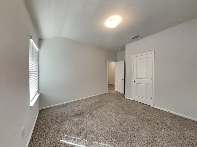 an empty room with windows and closet