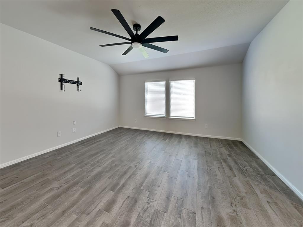 2313 Marshville Road Fort Worth, TX 76108 - Photo 3 of 17 an empty room with wooden floor and windows