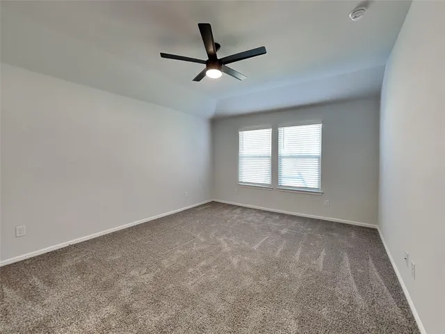a view of a livingroom with a ceiling fan and window