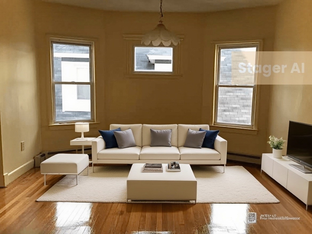 a living room with couches coffee table and a flat screen tv