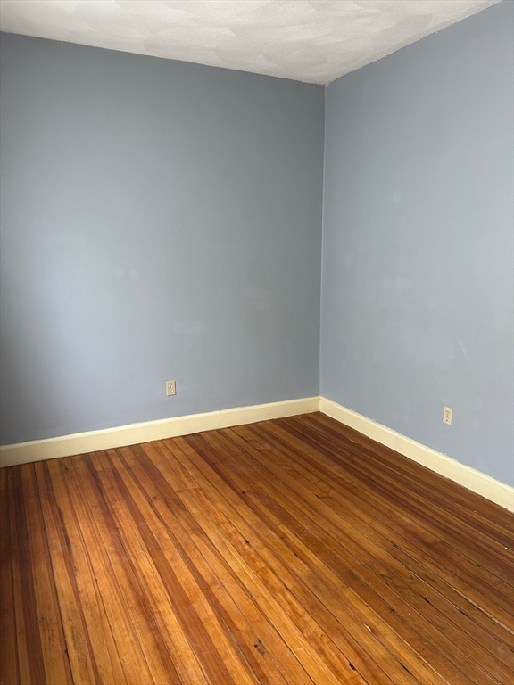 15 Harlem Street, Unit 3 Boston, MA 02121 - Photo 12 of 14 a view of empty room with wooden floor