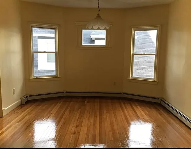 a view of an empty room and a window