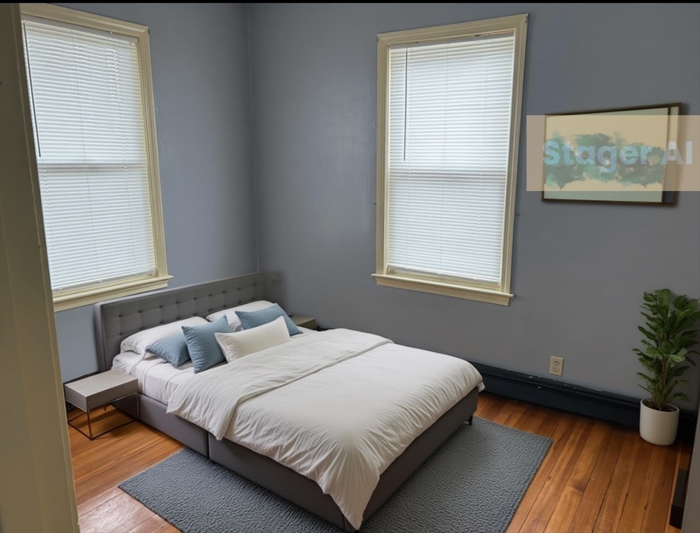 15 Harlem Street, Unit 3 Boston, MA 02121 - Photo 5 of 14 a bedroom with a bed and a window