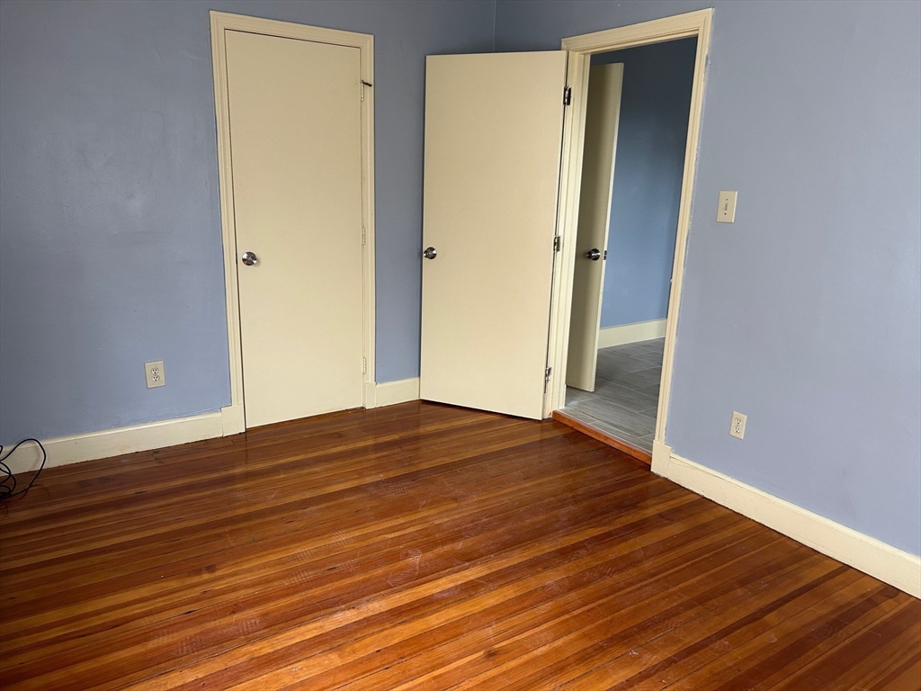 15 Harlem Street, Unit 3 Boston, MA 02121 - Photo 7 of 14 a view of empty room with wooden floor