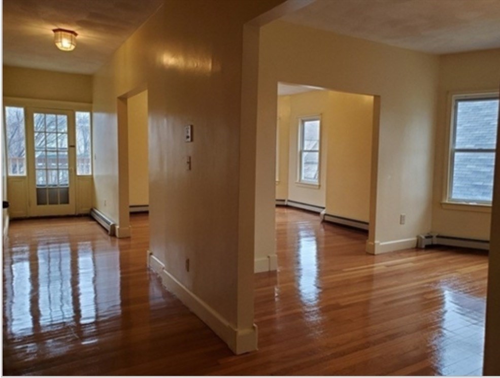 15 Harlem Street, Unit 3 Boston, MA 02121 - Photo 8 of 14 a view of a hallway with wooden floor and windows
