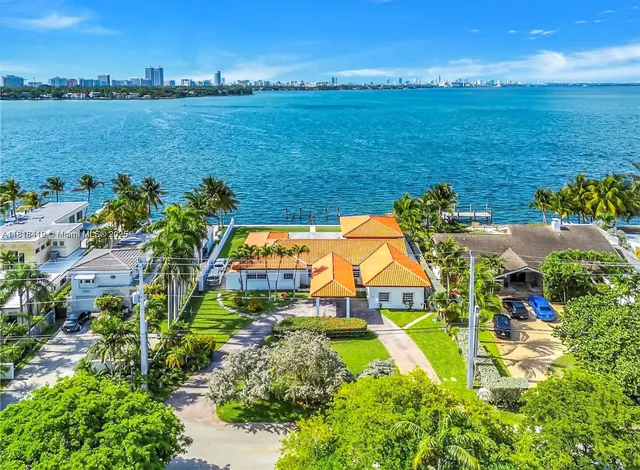 an aerial view of residential houses with outdoor space and swimming pool
