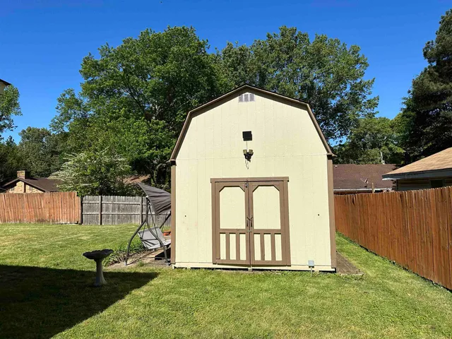 a view of backyard with swimming pool