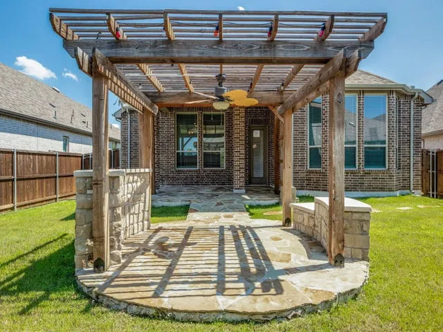 a view of a house with backyard porch and sitting area