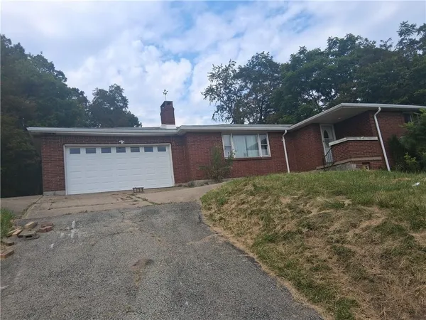 a view of a house with a yard and garage