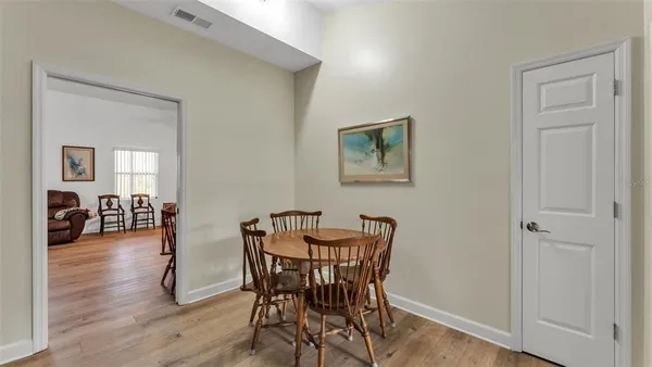 a dining room with furniture and wooden floor