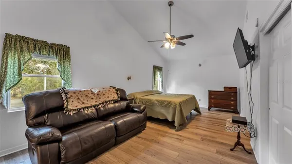 a bed room with a bed and a flat tv screen