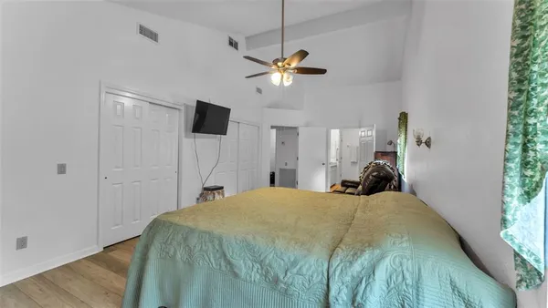 a bathroom with a granite countertop sink a mirror and shower