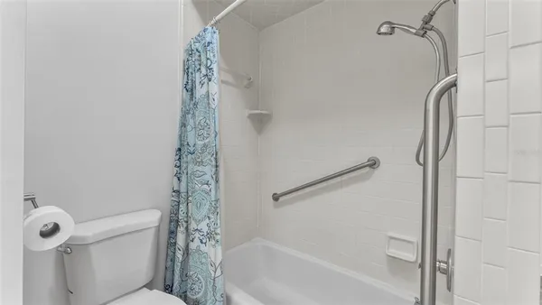 a living room with furniture and large windows